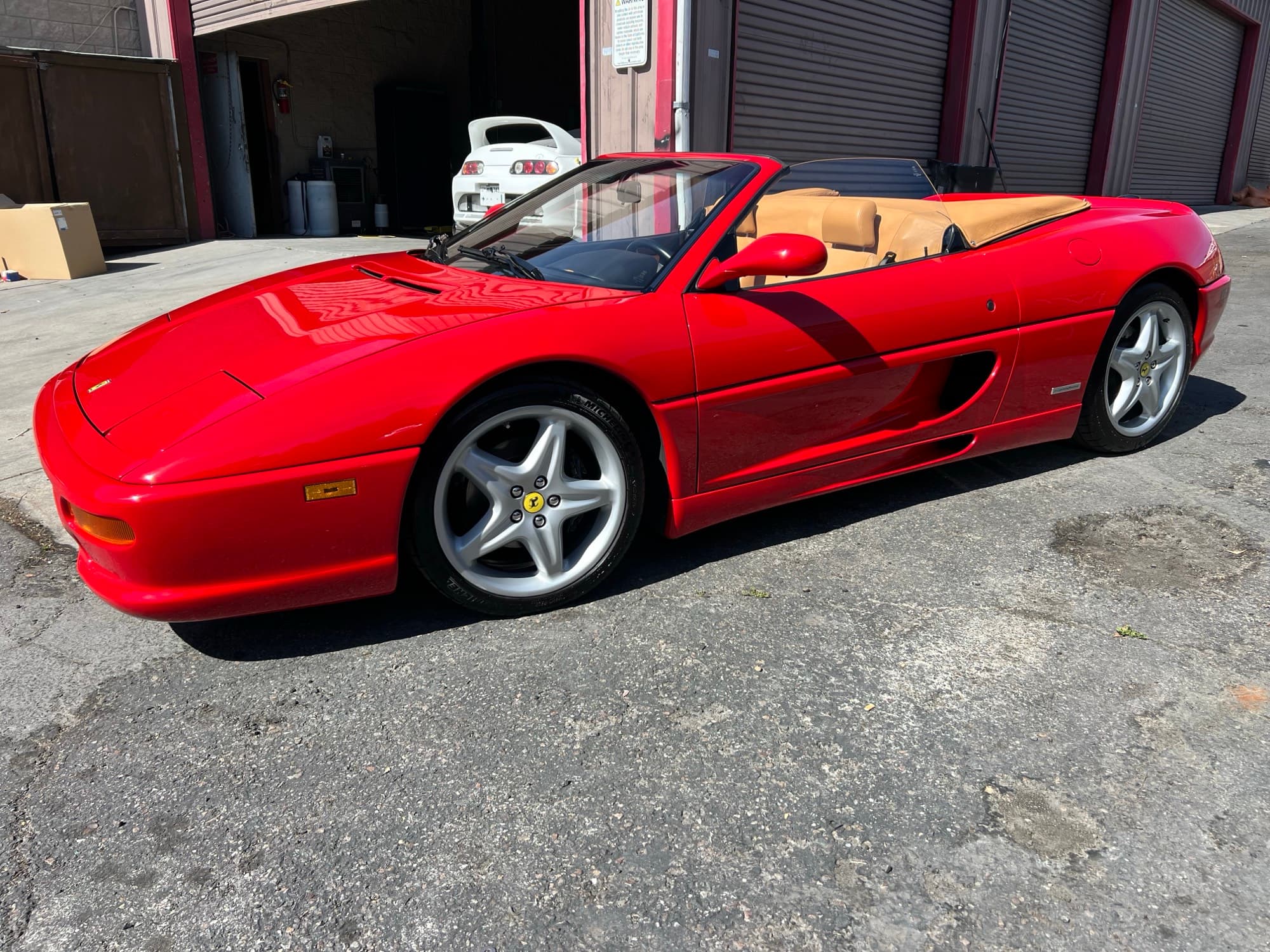 Red Ferrari F355 Spider parked at Crash Lab after paint correction and final polish